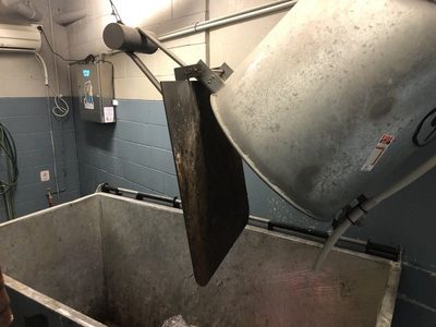 Garbage Doctor 3000 above a galvanised bin, the chute's hatch swung open over it