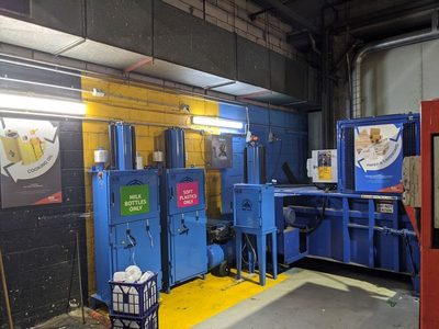 Garbage Doctor 3000 in a recycling room with balers for milk bottles, soft plastics and cardboard