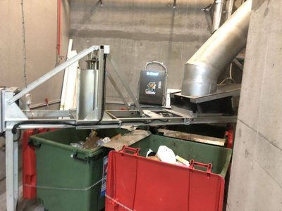 Garbage Doctor 5000 above a chute's bin changeover, its green and red bins full of recycling