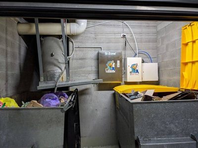 Garbage Doctor Scenting beside a Si-Zone ozone unit, over galvanised rubbish bins under the chute
