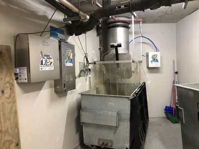 Garbage Doctor Scenting added to an Odour Doctor, beside a round chute over a galvanised bin