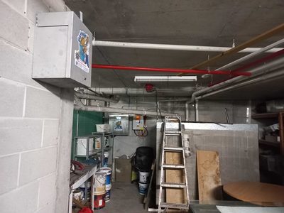 Garbage Doctor Duo high on the wall of a basement store and rubbish room