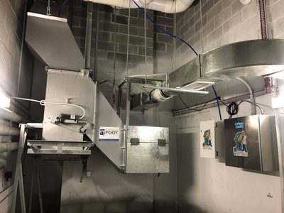 Garbage Doctor Duo beside an Elephants Foot chute discharge, conduit along the ceiling