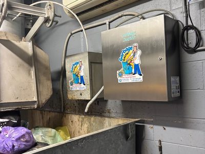 Garbage Doctor Duo and its scent tank beside the chute, over a galvanised bin of bagged rubbish