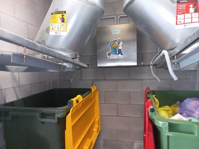 Garbage Doctor Ozone between two garbage chutes, for general waste and recycling, above their bins