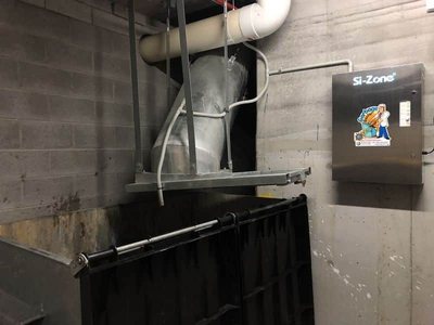 A Garbage Doctor Si-Zone 5000 beside a garbage chute over a large bin