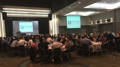 Purifying Solutions presenting to a full room at a trade event
