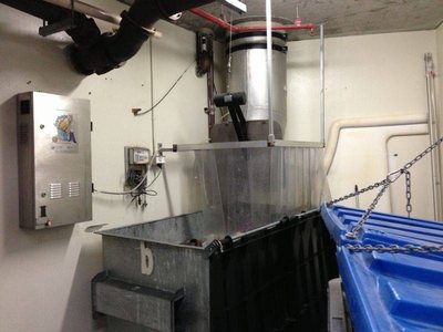 A Garbage Doctor Platinum beside a garbage chute over a large bin